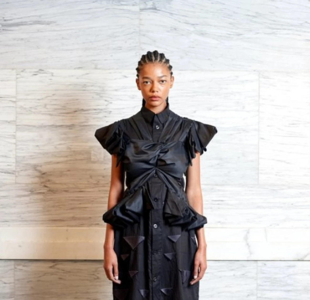 Phoebe English is a British designer known for her sustainable and meticulously crafted designs that prioritize slow fashion principles. Her collections often feature deconstructed silhouettes, hand-finished details, and a minimalist aesthetic.