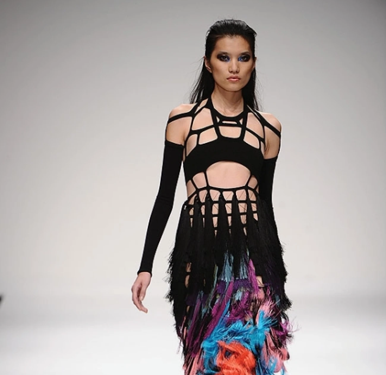 Mark Fast is a Canadian-born designer recognized for his innovative knitwear and body-hugging silhouettes. His designs often feature intricate, hand-knitted techniques that highlight the female form, blending modernity with traditional craftsmanship.