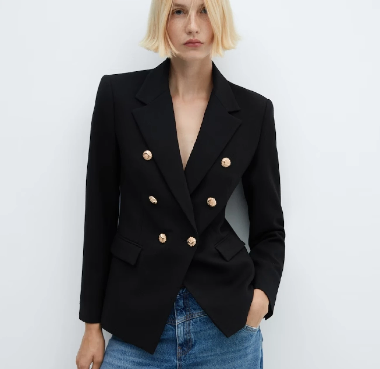 Model wearing a double breasted black blazer with golden buttons from the sale of the fashion label Mango. Goldfoil magazine is your go-to source for fashion inspiration and fashion deals on some of the best clothes