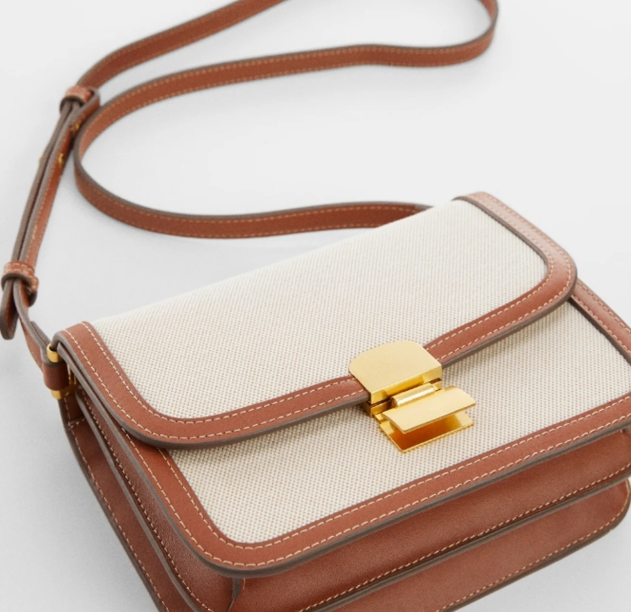 Mango crossbody canvas and leather bag with a flap and a golden clasp currently on sale