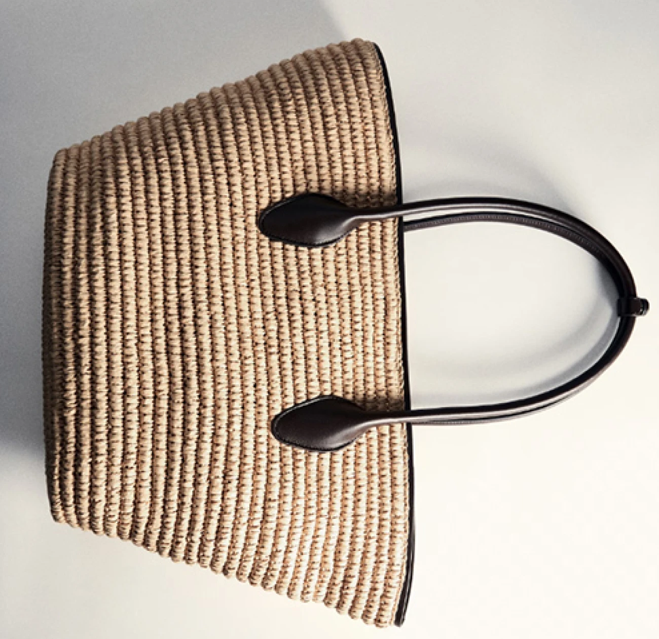 a summer tote bag from Mango currently at 50% off, in light woven texture, with contrast dark brown leather straps
