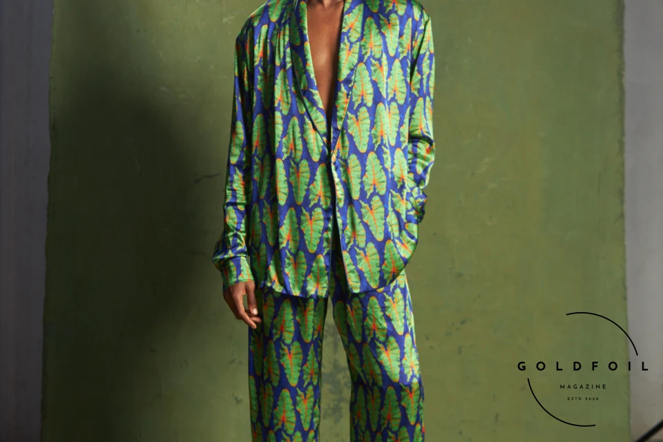 Banke Kuku Menswear  blue set - a relaxed blue blazer covered in green leaves matched with relaxed trousers and loafers in the same pattern Banke Kuku Menswear  blue set - a relaxed blue blazer covered in green leaves matched with relaxed trousers and loafers in the same pattern