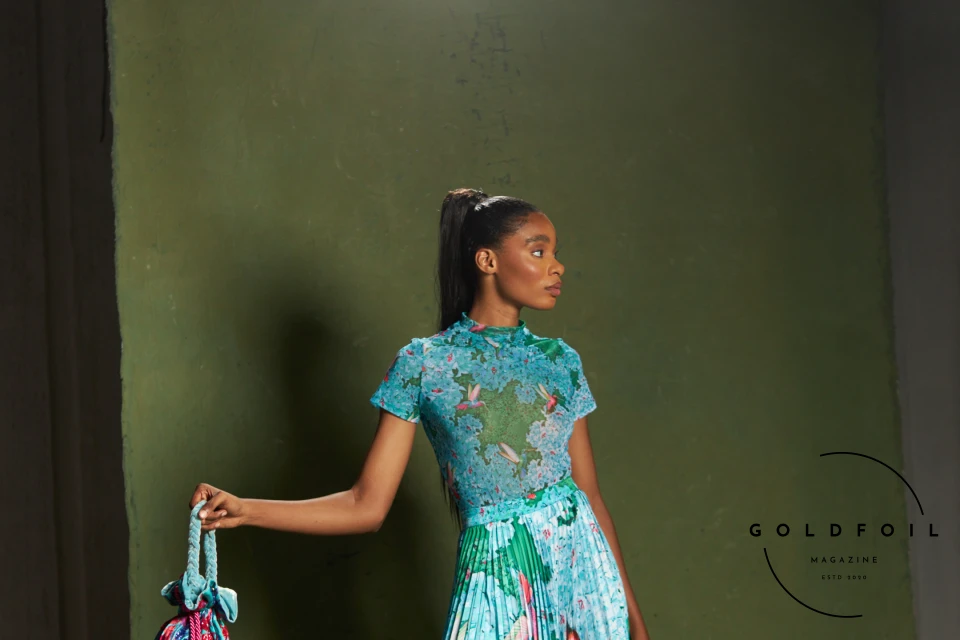 Banke Kuku showcases a colourful collection, in this photo we can see a long dress with a pleated bottom half in a stunning vibrant marine blue Banke Kuku showcases a colourful collection, in this photo we can see a long dress with a pleated bottom half in a stunning vibrant marine blue