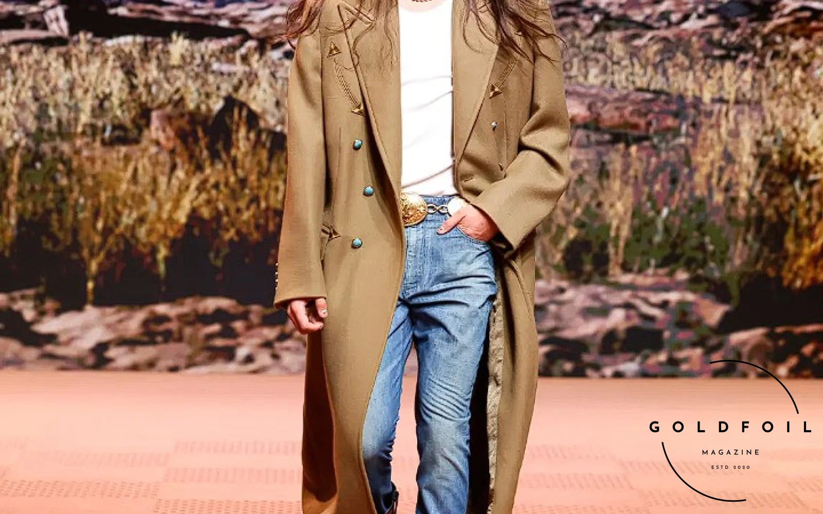 Long tan pea coat presented at the autumn winter showcase of Louis Vuitton in Paris by Pharrell Williams - features a cowboy hat and boots Long tan pea coat presented at the autumn winter showcase of Louis Vuitton in Paris by Pharrell Williams - features a cowboy hat and boots