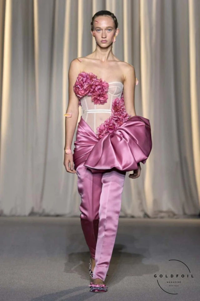 Giambattista Valli’s fall 2024 haute couture show in Paris was a vibrant spectacle, true to his signature voluminous tulle dresses while embracing an Indian influence. Held at 7 Place Vendôme, the show opened with Indian musicians and featured gowns blending Italian opulence with Indian floral motifs. Models wore bouquet-like dresses adorned with floating florals and jasmine garlands, creating a surreal mix of Valli's love for India and Botticelli-inspired paradise gardens. Giambattista Valli’s fall 2024 haute couture show in Paris was a vibrant spectacle, true to his signature voluminous tulle dresses while embracing an Indian influence. Held at 7 Place Vendôme, the show opened with Indian musicians and featured gowns blending Italian opulence with Indian floral motifs. Models wore bouquet-like dresses adorned with floating florals and jasmine garlands, creating a surreal mix of Valli's love for India and Botticelli-inspired paradise gardens.