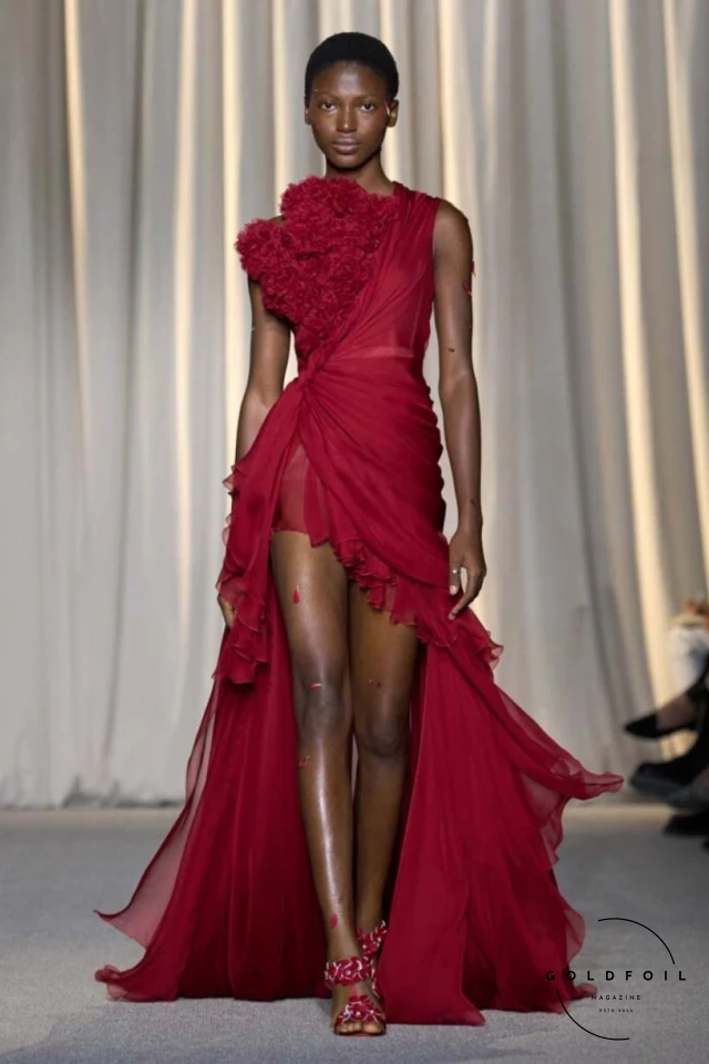 Giambattista Valli’s fall 2024 haute couture show in Paris was a vibrant spectacle, true to his signature voluminous tulle dresses while embracing an Indian influence. Held at 7 Place Vendôme, the show opened with Indian musicians and featured gowns blending Italian opulence with Indian floral motifs. Models wore bouquet-like dresses adorned with floating florals and jasmine garlands, creating a surreal mix of Valli's love for India and Botticelli-inspired paradise gardens. Giambattista Valli’s fall 2024 haute couture show in Paris was a vibrant spectacle, true to his signature voluminous tulle dresses while embracing an Indian influence. Held at 7 Place Vendôme, the show opened with Indian musicians and featured gowns blending Italian opulence with Indian floral motifs. Models wore bouquet-like dresses adorned with floating florals and jasmine garlands, creating a surreal mix of Valli's love for India and Botticelli-inspired paradise gardens.
