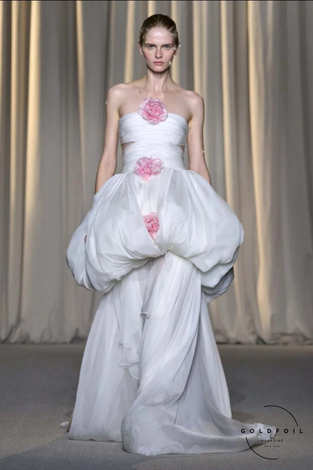 Giambattista Valli’s fall 2024 haute couture show in Paris was a vibrant spectacle, true to his signature voluminous tulle dresses while embracing an Indian influence. Held at 7 Place Vendôme, the show opened with Indian musicians and featured gowns blending Italian opulence with Indian floral motifs. Models wore bouquet-like dresses adorned with floating florals and jasmine garlands, creating a surreal mix of Valli's love for India and Botticelli-inspired paradise gardens. Giambattista Valli’s fall 2024 haute couture show in Paris was a vibrant spectacle, true to his signature voluminous tulle dresses while embracing an Indian influence. Held at 7 Place Vendôme, the show opened with Indian musicians and featured gowns blending Italian opulence with Indian floral motifs. Models wore bouquet-like dresses adorned with floating florals and jasmine garlands, creating a surreal mix of Valli's love for India and Botticelli-inspired paradise gardens.