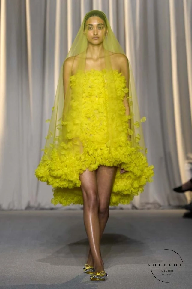 Giambattista Valli’s fall 2024 haute couture show in Paris was a vibrant spectacle, true to his signature voluminous tulle dresses while embracing an Indian influence. Held at 7 Place Vendôme, the show opened with Indian musicians and featured gowns blending Italian opulence with Indian floral motifs. Models wore bouquet-like dresses adorned with floating florals and jasmine garlands, creating a surreal mix of Valli's love for India and Botticelli-inspired paradise gardens. Giambattista Valli’s fall 2024 haute couture show in Paris was a vibrant spectacle, true to his signature voluminous tulle dresses while embracing an Indian influence. Held at 7 Place Vendôme, the show opened with Indian musicians and featured gowns blending Italian opulence with Indian floral motifs. Models wore bouquet-like dresses adorned with floating florals and jasmine garlands, creating a surreal mix of Valli's love for India and Botticelli-inspired paradise gardens.