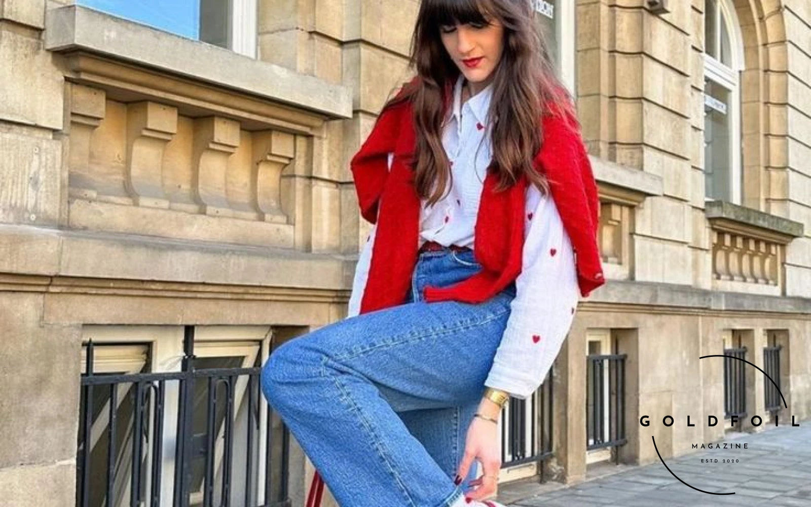 An Instagram influencer wears a pair of adidas gazelle sneakers in white and red stripes, paired with matching white socks with hearts and a white and red hearts shirt, with a red jumper over the back, wide jeans and a red bag An Instagram influencer wears a pair of adidas gazelle sneakers in white and red stripes, paired with matching white socks with hearts and a white and red hearts shirt, with a red jumper over the back, wide jeans and a red bag