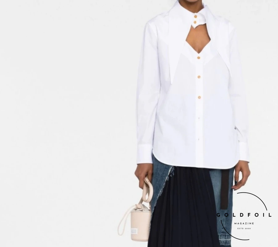 a Vivienne westwood cut out shirt in punk rock aesthetic compliments beautifully a black pleated skirt and a jacquemus bag to finish the adidas gazelle sneakers outfit a Vivienne westwood cut out shirt in punk rock aesthetic compliments beautifully a black pleated skirt and a jacquemus bag to finish the adidas gazelle sneakers outfit