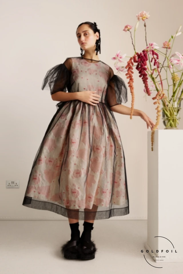 Simone Rocha is celebrated for her romantic and feminine designs that often feature delicate embellishments, intricate lace, and voluminous silhouettes. Her collections blend historical references with a contemporary sensibility. Simone Rocha is celebrated for her romantic and feminine designs that often feature delicate embellishments, intricate lace, and voluminous silhouettes. Her collections blend historical references with a contemporary sensibility.