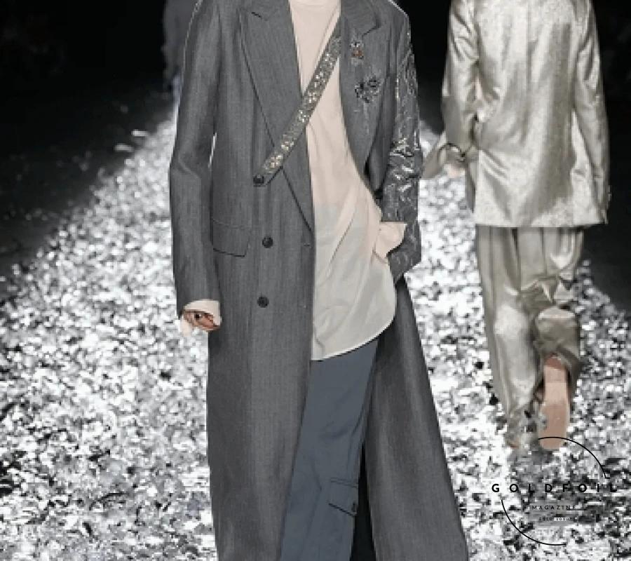Dries Van Noten’s Spring/Summer 2025 collection marks the culmination of his illustrious career, a final tribute to his profound impact on menswear since 1986. Announced in March 2024, his retirement sets the stage for a masterful and reflective showcase. The runway, adorned with silver foil, mirrored the fluid silhouettes and organic flow of creativity that Van Noten is celebrated for. This final collection beautifully blends timeless and modern elements, embodying his design philosophy and cementing his legacy in fashion history. Dries Van Noten’s Spring/Summer 2025 collection marks the culmination of his illustrious career, a final tribute to his profound impact on menswear since 1986. Announced in March 2024, his retirement sets the stage for a masterful and reflective showcase. The runway, adorned with silver foil, mirrored the fluid silhouettes and organic flow of creativity that Van Noten is celebrated for. This final collection beautifully blends timeless and modern elements, embodying his design philosophy and cementing his legacy in fashion history.