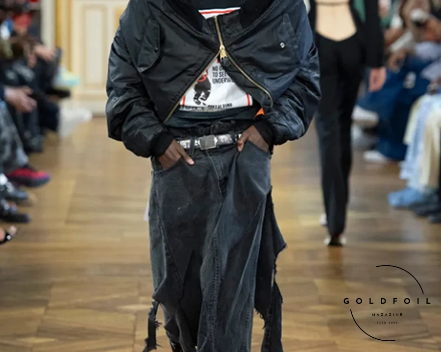 A$AP Rocky's debut at Paris Men’s Fashion Week, under his new brand American Sabotage presented by AWGE, critiqued the political and economic structures of the U.S. Held in Karl Lagerfeld’s former residence, the show attracted chaotic crowds eager to see Rihanna and other celebrities like Maluma and Pusha T. Rocky's collection featured bold designs, including a backless business suit and exaggerated layering inspired by hip-hop's sagging-pants style, with multiple boxer-short bands and stitched-together waistbands creating unique pieces. Rihanna made a dramatic entrance and captured the show from the front row, adding to the spectacle. A$AP Rocky's debut at Paris Men’s Fashion Week, under his new brand American Sabotage presented by AWGE, critiqued the political and economic structures of the U.S. Held in Karl Lagerfeld’s former residence, the show attracted chaotic crowds eager to see Rihanna and other celebrities like Maluma and Pusha T. Rocky's collection featured bold designs, including a backless business suit and exaggerated layering inspired by hip-hop's sagging-pants style, with multiple boxer-short bands and stitched-together waistbands creating unique pieces. Rihanna made a dramatic entrance and captured the show from the front row, adding to the spectacle.