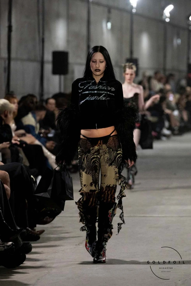 Namilia’s Spring/Summer 2025 runway show at Berlin Fashion Week was a visionary spectacle that fused futuristic design with potent social commentary. Designers Nan Li and Emilia Pfohl showcased a collection featuring high-tech fabrics, bold silhouettes, and symbolic embellishments depicting feminist icons. The use of biodegradable plastics, LED-embedded fabrics, and 3D-printed accessories highlighted the brand's commitment to sustainability, while oversized visors, holographic boots, and avant-garde jewellery added to the futuristic aesthetic. Multimedia presentations on gender equality, body positivity, and climate change underscored the show’s activist message, earning critical acclaim and reinforcing Namilia’s reputation for pushing fashion’s boundaries and inspiring change. Namilia’s Spring/Summer 2025 runway show at Berlin Fashion Week was a visionary spectacle that fused futuristic design with potent social commentary. Designers Nan Li and Emilia Pfohl showcased a collection featuring high-tech fabrics, bold silhouettes, and symbolic embellishments depicting feminist icons. The use of biodegradable plastics, LED-embedded fabrics, and 3D-printed accessories highlighted the brand's commitment to sustainability, while oversized visors, holographic boots, and avant-garde jewellery added to the futuristic aesthetic. Multimedia presentations on gender equality, body positivity, and climate change underscored the show’s activist message, earning critical acclaim and reinforcing Namilia’s reputation for pushing fashion’s boundaries and inspiring change.