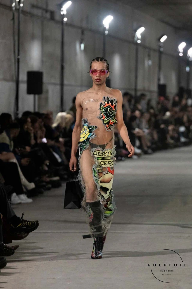 Namilia’s Spring/Summer 2025 runway show at Berlin Fashion Week was a visionary spectacle that fused futuristic design with potent social commentary. Designers Nan Li and Emilia Pfohl showcased a collection featuring high-tech fabrics, bold silhouettes, and symbolic embellishments depicting feminist icons. The use of biodegradable plastics, LED-embedded fabrics, and 3D-printed accessories highlighted the brand's commitment to sustainability, while oversized visors, holographic boots, and avant-garde jewellery added to the futuristic aesthetic. Multimedia presentations on gender equality, body positivity, and climate change underscored the show’s activist message, earning critical acclaim and reinforcing Namilia’s reputation for pushing fashion’s boundaries and inspiring change. Namilia’s Spring/Summer 2025 runway show at Berlin Fashion Week was a visionary spectacle that fused futuristic design with potent social commentary. Designers Nan Li and Emilia Pfohl showcased a collection featuring high-tech fabrics, bold silhouettes, and symbolic embellishments depicting feminist icons. The use of biodegradable plastics, LED-embedded fabrics, and 3D-printed accessories highlighted the brand's commitment to sustainability, while oversized visors, holographic boots, and avant-garde jewellery added to the futuristic aesthetic. Multimedia presentations on gender equality, body positivity, and climate change underscored the show’s activist message, earning critical acclaim and reinforcing Namilia’s reputation for pushing fashion’s boundaries and inspiring change.