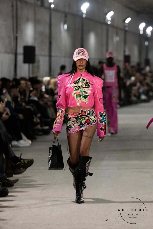 Namilia’s Spring/Summer 2025 runway show at Berlin Fashion Week was a visionary spectacle that fused futuristic design with potent social commentary. Designers Nan Li and Emilia Pfohl showcased a collection featuring high-tech fabrics, bold silhouettes, and symbolic embellishments depicting feminist icons. The use of biodegradable plastics, LED-embedded fabrics, and 3D-printed accessories highlighted the brand's commitment to sustainability, while oversized visors, holographic boots, and avant-garde jewellery added to the futuristic aesthetic. Multimedia presentations on gender equality, body positivity, and climate change underscored the show’s activist message, earning critical acclaim and reinforcing Namilia’s reputation for pushing fashion’s boundaries and inspiring change. Namilia’s Spring/Summer 2025 runway show at Berlin Fashion Week was a visionary spectacle that fused futuristic design with potent social commentary. Designers Nan Li and Emilia Pfohl showcased a collection featuring high-tech fabrics, bold silhouettes, and symbolic embellishments depicting feminist icons. The use of biodegradable plastics, LED-embedded fabrics, and 3D-printed accessories highlighted the brand's commitment to sustainability, while oversized visors, holographic boots, and avant-garde jewellery added to the futuristic aesthetic. Multimedia presentations on gender equality, body positivity, and climate change underscored the show’s activist message, earning critical acclaim and reinforcing Namilia’s reputation for pushing fashion’s boundaries and inspiring change.