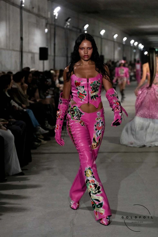 Namilia’s Spring/Summer 2025 runway show at Berlin Fashion Week was a visionary spectacle that fused futuristic design with potent social commentary. Designers Nan Li and Emilia Pfohl showcased a collection featuring high-tech fabrics, bold silhouettes, and symbolic embellishments depicting feminist icons. The use of biodegradable plastics, LED-embedded fabrics, and 3D-printed accessories highlighted the brand's commitment to sustainability, while oversized visors, holographic boots, and avant-garde jewellery added to the futuristic aesthetic. Multimedia presentations on gender equality, body positivity, and climate change underscored the show’s activist message, earning critical acclaim and reinforcing Namilia’s reputation for pushing fashion’s boundaries and inspiring change. Namilia’s Spring/Summer 2025 runway show at Berlin Fashion Week was a visionary spectacle that fused futuristic design with potent social commentary. Designers Nan Li and Emilia Pfohl showcased a collection featuring high-tech fabrics, bold silhouettes, and symbolic embellishments depicting feminist icons. The use of biodegradable plastics, LED-embedded fabrics, and 3D-printed accessories highlighted the brand's commitment to sustainability, while oversized visors, holographic boots, and avant-garde jewellery added to the futuristic aesthetic. Multimedia presentations on gender equality, body positivity, and climate change underscored the show’s activist message, earning critical acclaim and reinforcing Namilia’s reputation for pushing fashion’s boundaries and inspiring change.