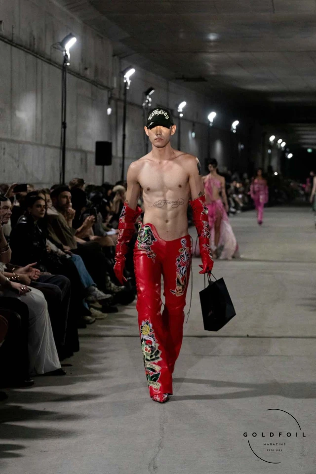 Namilia’s Spring/Summer 2025 runway show at Berlin Fashion Week was a visionary spectacle that fused futuristic design with potent social commentary. Designers Nan Li and Emilia Pfohl showcased a collection featuring high-tech fabrics, bold silhouettes, and symbolic embellishments depicting feminist icons. The use of biodegradable plastics, LED-embedded fabrics, and 3D-printed accessories highlighted the brand's commitment to sustainability, while oversized visors, holographic boots, and avant-garde jewellery added to the futuristic aesthetic. Multimedia presentations on gender equality, body positivity, and climate change underscored the show’s activist message, earning critical acclaim and reinforcing Namilia’s reputation for pushing fashion’s boundaries and inspiring change. Namilia’s Spring/Summer 2025 runway show at Berlin Fashion Week was a visionary spectacle that fused futuristic design with potent social commentary. Designers Nan Li and Emilia Pfohl showcased a collection featuring high-tech fabrics, bold silhouettes, and symbolic embellishments depicting feminist icons. The use of biodegradable plastics, LED-embedded fabrics, and 3D-printed accessories highlighted the brand's commitment to sustainability, while oversized visors, holographic boots, and avant-garde jewellery added to the futuristic aesthetic. Multimedia presentations on gender equality, body positivity, and climate change underscored the show’s activist message, earning critical acclaim and reinforcing Namilia’s reputation for pushing fashion’s boundaries and inspiring change.