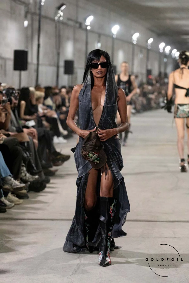 Namilia’s Spring/Summer 2025 runway show at Berlin Fashion Week was a visionary spectacle that fused futuristic design with potent social commentary. Designers Nan Li and Emilia Pfohl showcased a collection featuring high-tech fabrics, bold silhouettes, and symbolic embellishments depicting feminist icons. The use of biodegradable plastics, LED-embedded fabrics, and 3D-printed accessories highlighted the brand's commitment to sustainability, while oversized visors, holographic boots, and avant-garde jewellery added to the futuristic aesthetic. Multimedia presentations on gender equality, body positivity, and climate change underscored the show’s activist message, earning critical acclaim and reinforcing Namilia’s reputation for pushing fashion’s boundaries and inspiring change. Namilia’s Spring/Summer 2025 runway show at Berlin Fashion Week was a visionary spectacle that fused futuristic design with potent social commentary. Designers Nan Li and Emilia Pfohl showcased a collection featuring high-tech fabrics, bold silhouettes, and symbolic embellishments depicting feminist icons. The use of biodegradable plastics, LED-embedded fabrics, and 3D-printed accessories highlighted the brand's commitment to sustainability, while oversized visors, holographic boots, and avant-garde jewellery added to the futuristic aesthetic. Multimedia presentations on gender equality, body positivity, and climate change underscored the show’s activist message, earning critical acclaim and reinforcing Namilia’s reputation for pushing fashion’s boundaries and inspiring change.