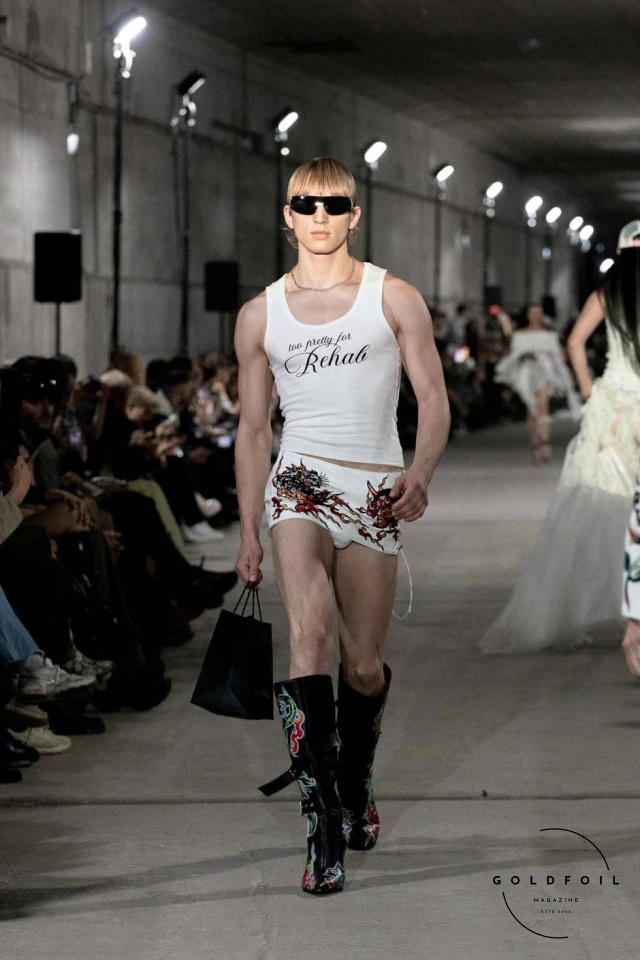 Namilia’s Spring/Summer 2025 runway show at Berlin Fashion Week was a visionary spectacle that fused futuristic design with potent social commentary. Designers Nan Li and Emilia Pfohl showcased a collection featuring high-tech fabrics, bold silhouettes, and symbolic embellishments depicting feminist icons. The use of biodegradable plastics, LED-embedded fabrics, and 3D-printed accessories highlighted the brand's commitment to sustainability, while oversized visors, holographic boots, and avant-garde jewellery added to the futuristic aesthetic. Multimedia presentations on gender equality, body positivity, and climate change underscored the show’s activist message, earning critical acclaim and reinforcing Namilia’s reputation for pushing fashion’s boundaries and inspiring change. Namilia’s Spring/Summer 2025 runway show at Berlin Fashion Week was a visionary spectacle that fused futuristic design with potent social commentary. Designers Nan Li and Emilia Pfohl showcased a collection featuring high-tech fabrics, bold silhouettes, and symbolic embellishments depicting feminist icons. The use of biodegradable plastics, LED-embedded fabrics, and 3D-printed accessories highlighted the brand's commitment to sustainability, while oversized visors, holographic boots, and avant-garde jewellery added to the futuristic aesthetic. Multimedia presentations on gender equality, body positivity, and climate change underscored the show’s activist message, earning critical acclaim and reinforcing Namilia’s reputation for pushing fashion’s boundaries and inspiring change.