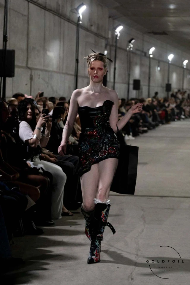 Namilia’s Spring/Summer 2025 runway show at Berlin Fashion Week was a visionary spectacle that fused futuristic design with potent social commentary. Designers Nan Li and Emilia Pfohl showcased a collection featuring high-tech fabrics, bold silhouettes, and symbolic embellishments depicting feminist icons. The use of biodegradable plastics, LED-embedded fabrics, and 3D-printed accessories highlighted the brand's commitment to sustainability, while oversized visors, holographic boots, and avant-garde jewellery added to the futuristic aesthetic. Multimedia presentations on gender equality, body positivity, and climate change underscored the show’s activist message, earning critical acclaim and reinforcing Namilia’s reputation for pushing fashion’s boundaries and inspiring change. Namilia’s Spring/Summer 2025 runway show at Berlin Fashion Week was a visionary spectacle that fused futuristic design with potent social commentary. Designers Nan Li and Emilia Pfohl showcased a collection featuring high-tech fabrics, bold silhouettes, and symbolic embellishments depicting feminist icons. The use of biodegradable plastics, LED-embedded fabrics, and 3D-printed accessories highlighted the brand's commitment to sustainability, while oversized visors, holographic boots, and avant-garde jewellery added to the futuristic aesthetic. Multimedia presentations on gender equality, body positivity, and climate change underscored the show’s activist message, earning critical acclaim and reinforcing Namilia’s reputation for pushing fashion’s boundaries and inspiring change.