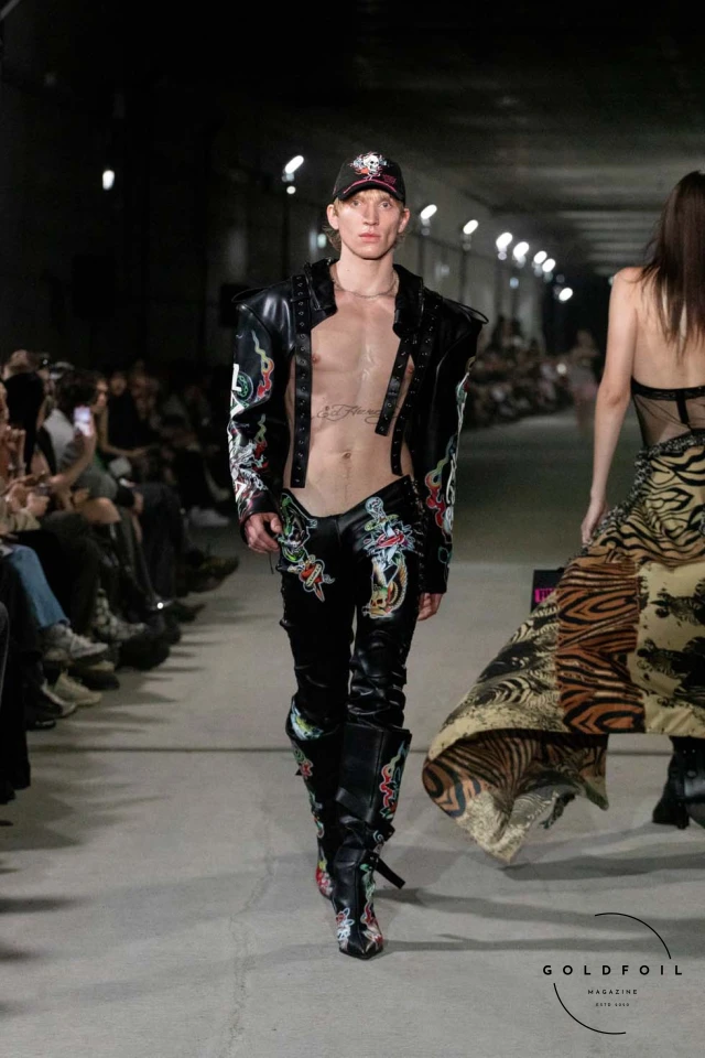 Namilia’s Spring/Summer 2025 runway show at Berlin Fashion Week was a visionary spectacle that fused futuristic design with potent social commentary. Designers Nan Li and Emilia Pfohl showcased a collection featuring high-tech fabrics, bold silhouettes, and symbolic embellishments depicting feminist icons. The use of biodegradable plastics, LED-embedded fabrics, and 3D-printed accessories highlighted the brand's commitment to sustainability, while oversized visors, holographic boots, and avant-garde jewellery added to the futuristic aesthetic. Multimedia presentations on gender equality, body positivity, and climate change underscored the show’s activist message, earning critical acclaim and reinforcing Namilia’s reputation for pushing fashion’s boundaries and inspiring change. Namilia’s Spring/Summer 2025 runway show at Berlin Fashion Week was a visionary spectacle that fused futuristic design with potent social commentary. Designers Nan Li and Emilia Pfohl showcased a collection featuring high-tech fabrics, bold silhouettes, and symbolic embellishments depicting feminist icons. The use of biodegradable plastics, LED-embedded fabrics, and 3D-printed accessories highlighted the brand's commitment to sustainability, while oversized visors, holographic boots, and avant-garde jewellery added to the futuristic aesthetic. Multimedia presentations on gender equality, body positivity, and climate change underscored the show’s activist message, earning critical acclaim and reinforcing Namilia’s reputation for pushing fashion’s boundaries and inspiring change.