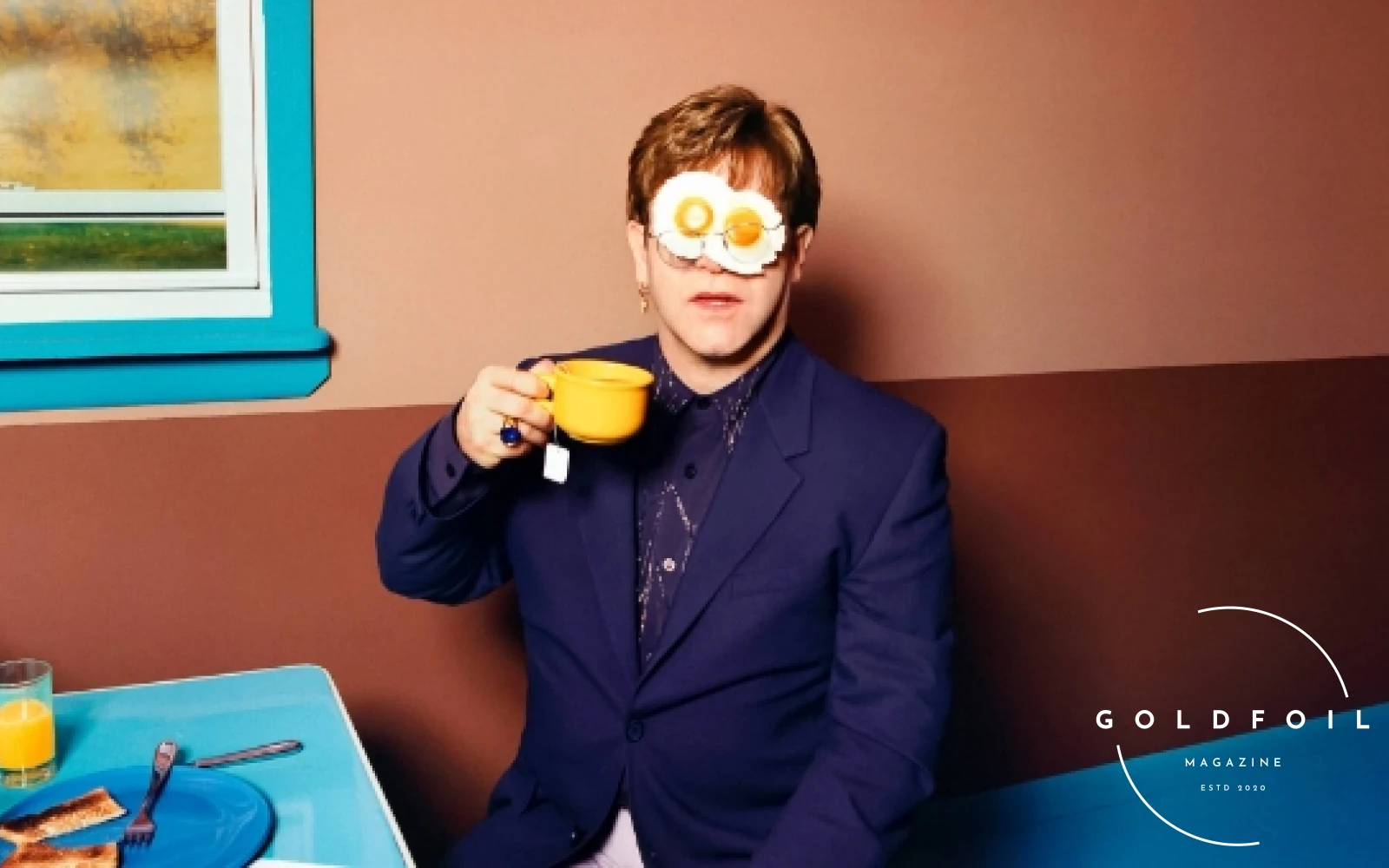 Fragile Beauty exhibition at the V&A Museum one of the best things to do in london this summer. Pictured young elton john in a photograph with eggs on his face and a cup of tea in hand Fragile Beauty exhibition at the V&A Museum one of the best things to do in london this summer. Pictured young elton john in a photograph with eggs on his face and a cup of tea in hand