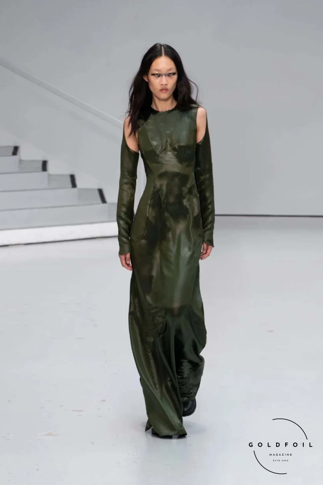 Yenesai’s latest collection, inspired by the desert biome, offers innovative solutions and challenges through color theory, soft fabrics, refined basics, and explorative accessories tailored for the future nomad. Emphasizing functionality, the collection includes garments that facilitate movement and action, while incorporating harvested resources like crystals and essential oils in their new clear resin canister bag. Advances in 3D-printed accessories, including a cyborg hand clasp and redesigned eyewear, reflect the nomad’s evolving relationship with the environment, showcased in shiny, flecked fabrics and gemstone-inspired textures. The show concludes with leather looks featuring intricate paneling and armor-style layering. Yenesai, named after the Yenesai River, blends futuristic vision with ancestral nomadic values, offering technical fabrics and striking silhouettes for a global community of travelers, and fostering creative collaboration through retreats and events. Yenesai’s latest collection, inspired by the desert biome, offers innovative solutions and challenges through color theory, soft fabrics, refined basics, and explorative accessories tailored for the future nomad. Emphasizing functionality, the collection includes garments that facilitate movement and action, while incorporating harvested resources like crystals and essential oils in their new clear resin canister bag. Advances in 3D-printed accessories, including a cyborg hand clasp and redesigned eyewear, reflect the nomad’s evolving relationship with the environment, showcased in shiny, flecked fabrics and gemstone-inspired textures. The show concludes with leather looks featuring intricate paneling and armor-style layering. Yenesai, named after the Yenesai River, blends futuristic vision with ancestral nomadic values, offering technical fabrics and striking silhouettes for a global community of travelers, and fostering creative collaboration through retreats and events.