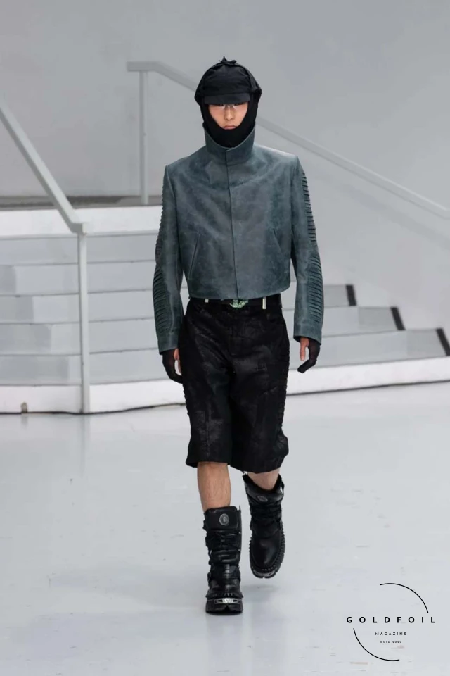 Yenesai’s latest collection, inspired by the desert biome, offers innovative solutions and challenges through color theory, soft fabrics, refined basics, and explorative accessories tailored for the future nomad. Emphasizing functionality, the collection includes garments that facilitate movement and action, while incorporating harvested resources like crystals and essential oils in their new clear resin canister bag. Advances in 3D-printed accessories, including a cyborg hand clasp and redesigned eyewear, reflect the nomad’s evolving relationship with the environment, showcased in shiny, flecked fabrics and gemstone-inspired textures. The show concludes with leather looks featuring intricate paneling and armor-style layering. Yenesai, named after the Yenesai River, blends futuristic vision with ancestral nomadic values, offering technical fabrics and striking silhouettes for a global community of travelers, and fostering creative collaboration through retreats and events. Yenesai’s latest collection, inspired by the desert biome, offers innovative solutions and challenges through color theory, soft fabrics, refined basics, and explorative accessories tailored for the future nomad. Emphasizing functionality, the collection includes garments that facilitate movement and action, while incorporating harvested resources like crystals and essential oils in their new clear resin canister bag. Advances in 3D-printed accessories, including a cyborg hand clasp and redesigned eyewear, reflect the nomad’s evolving relationship with the environment, showcased in shiny, flecked fabrics and gemstone-inspired textures. The show concludes with leather looks featuring intricate paneling and armor-style layering. Yenesai, named after the Yenesai River, blends futuristic vision with ancestral nomadic values, offering technical fabrics and striking silhouettes for a global community of travelers, and fostering creative collaboration through retreats and events.