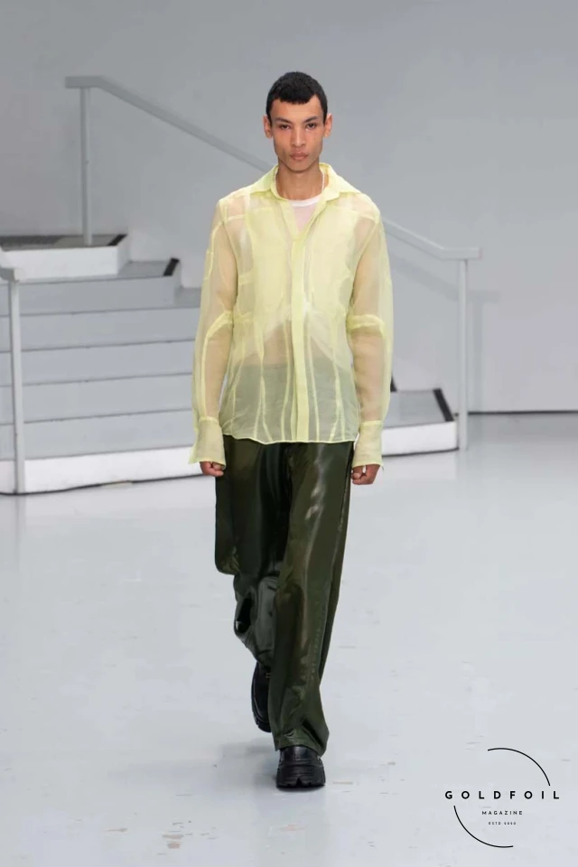 Yenesai’s latest collection, inspired by the desert biome, offers innovative solutions and challenges through color theory, soft fabrics, refined basics, and explorative accessories tailored for the future nomad. Emphasizing functionality, the collection includes garments that facilitate movement and action, while incorporating harvested resources like crystals and essential oils in their new clear resin canister bag. Advances in 3D-printed accessories, including a cyborg hand clasp and redesigned eyewear, reflect the nomad’s evolving relationship with the environment, showcased in shiny, flecked fabrics and gemstone-inspired textures. The show concludes with leather looks featuring intricate paneling and armor-style layering. Yenesai, named after the Yenesai River, blends futuristic vision with ancestral nomadic values, offering technical fabrics and striking silhouettes for a global community of travelers, and fostering creative collaboration through retreats and events. Yenesai’s latest collection, inspired by the desert biome, offers innovative solutions and challenges through color theory, soft fabrics, refined basics, and explorative accessories tailored for the future nomad. Emphasizing functionality, the collection includes garments that facilitate movement and action, while incorporating harvested resources like crystals and essential oils in their new clear resin canister bag. Advances in 3D-printed accessories, including a cyborg hand clasp and redesigned eyewear, reflect the nomad’s evolving relationship with the environment, showcased in shiny, flecked fabrics and gemstone-inspired textures. The show concludes with leather looks featuring intricate paneling and armor-style layering. Yenesai, named after the Yenesai River, blends futuristic vision with ancestral nomadic values, offering technical fabrics and striking silhouettes for a global community of travelers, and fostering creative collaboration through retreats and events.