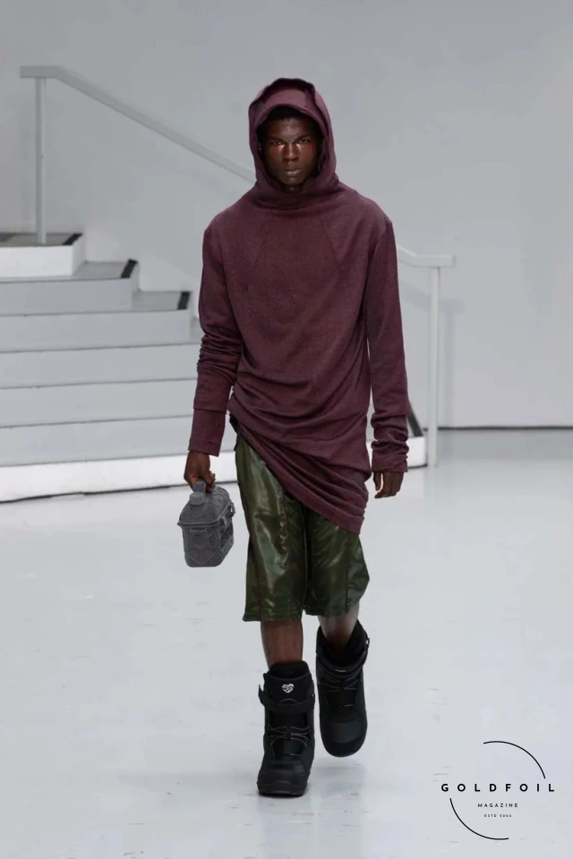 Yenesai’s latest collection, inspired by the desert biome, offers innovative solutions and challenges through color theory, soft fabrics, refined basics, and explorative accessories tailored for the future nomad. Emphasizing functionality, the collection includes garments that facilitate movement and action, while incorporating harvested resources like crystals and essential oils in their new clear resin canister bag. Advances in 3D-printed accessories, including a cyborg hand clasp and redesigned eyewear, reflect the nomad’s evolving relationship with the environment, showcased in shiny, flecked fabrics and gemstone-inspired textures. The show concludes with leather looks featuring intricate paneling and armor-style layering. Yenesai, named after the Yenesai River, blends futuristic vision with ancestral nomadic values, offering technical fabrics and striking silhouettes for a global community of travelers, and fostering creative collaboration through retreats and events. Yenesai’s latest collection, inspired by the desert biome, offers innovative solutions and challenges through color theory, soft fabrics, refined basics, and explorative accessories tailored for the future nomad. Emphasizing functionality, the collection includes garments that facilitate movement and action, while incorporating harvested resources like crystals and essential oils in their new clear resin canister bag. Advances in 3D-printed accessories, including a cyborg hand clasp and redesigned eyewear, reflect the nomad’s evolving relationship with the environment, showcased in shiny, flecked fabrics and gemstone-inspired textures. The show concludes with leather looks featuring intricate paneling and armor-style layering. Yenesai, named after the Yenesai River, blends futuristic vision with ancestral nomadic values, offering technical fabrics and striking silhouettes for a global community of travelers, and fostering creative collaboration through retreats and events.