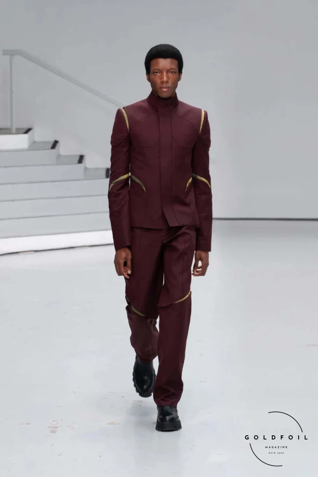 Yenesai’s latest collection, inspired by the desert biome, offers innovative solutions and challenges through color theory, soft fabrics, refined basics, and explorative accessories tailored for the future nomad. Emphasizing functionality, the collection includes garments that facilitate movement and action, while incorporating harvested resources like crystals and essential oils in their new clear resin canister bag. Advances in 3D-printed accessories, including a cyborg hand clasp and redesigned eyewear, reflect the nomad’s evolving relationship with the environment, showcased in shiny, flecked fabrics and gemstone-inspired textures. The show concludes with leather looks featuring intricate paneling and armor-style layering. Yenesai, named after the Yenesai River, blends futuristic vision with ancestral nomadic values, offering technical fabrics and striking silhouettes for a global community of travelers, and fostering creative collaboration through retreats and events. Yenesai’s latest collection, inspired by the desert biome, offers innovative solutions and challenges through color theory, soft fabrics, refined basics, and explorative accessories tailored for the future nomad. Emphasizing functionality, the collection includes garments that facilitate movement and action, while incorporating harvested resources like crystals and essential oils in their new clear resin canister bag. Advances in 3D-printed accessories, including a cyborg hand clasp and redesigned eyewear, reflect the nomad’s evolving relationship with the environment, showcased in shiny, flecked fabrics and gemstone-inspired textures. The show concludes with leather looks featuring intricate paneling and armor-style layering. Yenesai, named after the Yenesai River, blends futuristic vision with ancestral nomadic values, offering technical fabrics and striking silhouettes for a global community of travelers, and fostering creative collaboration through retreats and events.