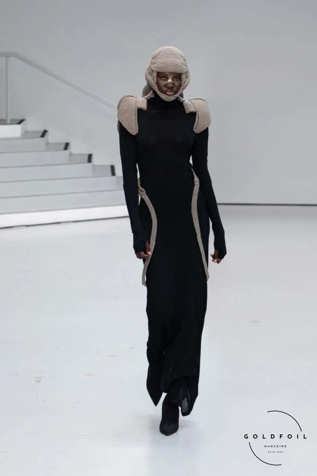 Yenesai’s latest collection, inspired by the desert biome, offers innovative solutions and challenges through color theory, soft fabrics, refined basics, and explorative accessories tailored for the future nomad. Emphasizing functionality, the collection includes garments that facilitate movement and action, while incorporating harvested resources like crystals and essential oils in their new clear resin canister bag. Advances in 3D-printed accessories, including a cyborg hand clasp and redesigned eyewear, reflect the nomad’s evolving relationship with the environment, showcased in shiny, flecked fabrics and gemstone-inspired textures. The show concludes with leather looks featuring intricate paneling and armor-style layering. Yenesai, named after the Yenesai River, blends futuristic vision with ancestral nomadic values, offering technical fabrics and striking silhouettes for a global community of travelers, and fostering creative collaboration through retreats and events. Yenesai’s latest collection, inspired by the desert biome, offers innovative solutions and challenges through color theory, soft fabrics, refined basics, and explorative accessories tailored for the future nomad. Emphasizing functionality, the collection includes garments that facilitate movement and action, while incorporating harvested resources like crystals and essential oils in their new clear resin canister bag. Advances in 3D-printed accessories, including a cyborg hand clasp and redesigned eyewear, reflect the nomad’s evolving relationship with the environment, showcased in shiny, flecked fabrics and gemstone-inspired textures. The show concludes with leather looks featuring intricate paneling and armor-style layering. Yenesai, named after the Yenesai River, blends futuristic vision with ancestral nomadic values, offering technical fabrics and striking silhouettes for a global community of travelers, and fostering creative collaboration through retreats and events.