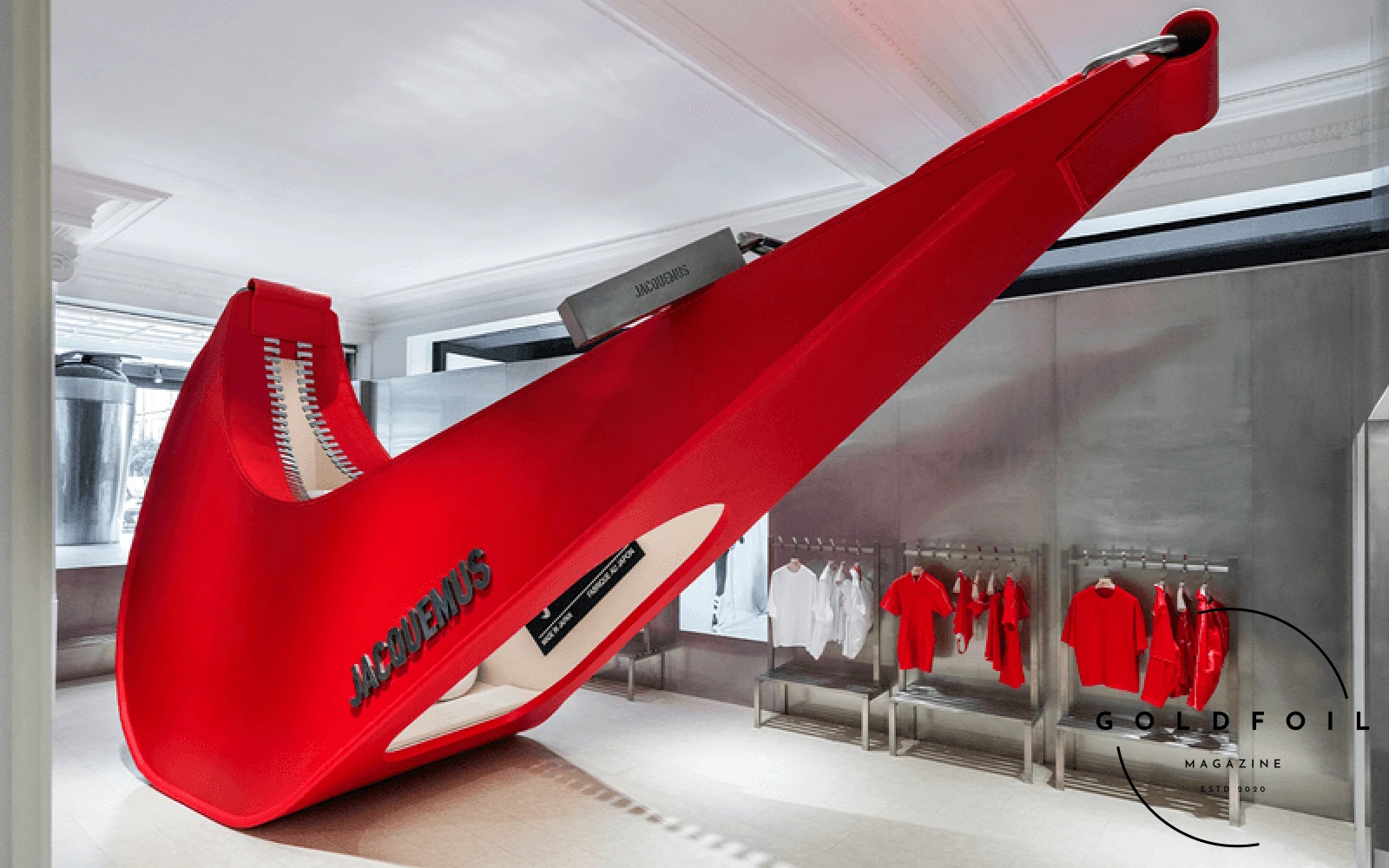 Nike and Jacquemus have launched their latest collaboration with an interactive pop-up at Selfridges' Wonder Room in London. The centerpiece, a revamped Air Max 1, is showcased in a space inspired by gym locker rooms, featuring enlarged Swoosh sculptures and a blend of white and red tones. The installation includes oversized workout equipment and exclusive Nike x Jacquemus pressed juices, merging fashion with functionality. Celebrating the 2024 Paris Olympics, the window display mimics a gym locker, reflecting the playful yet sophisticated spirit of the collection. Simon Porte Jacquemus draws inspiration from both Nike's athletic legacy and his own vintage collection, creating a luxurious tribute to the world of sport. Nike and Jacquemus have launched their latest collaboration with an interactive pop-up at Selfridges' Wonder Room in London. The centerpiece, a revamped Air Max 1, is showcased in a space inspired by gym locker rooms, featuring enlarged Swoosh sculptures and a blend of white and red tones. The installation includes oversized workout equipment and exclusive Nike x Jacquemus pressed juices, merging fashion with functionality. Celebrating the 2024 Paris Olympics, the window display mimics a gym locker, reflecting the playful yet sophisticated spirit of the collection. Simon Porte Jacquemus draws inspiration from both Nike's athletic legacy and his own vintage collection, creating a luxurious tribute to the world of sport.