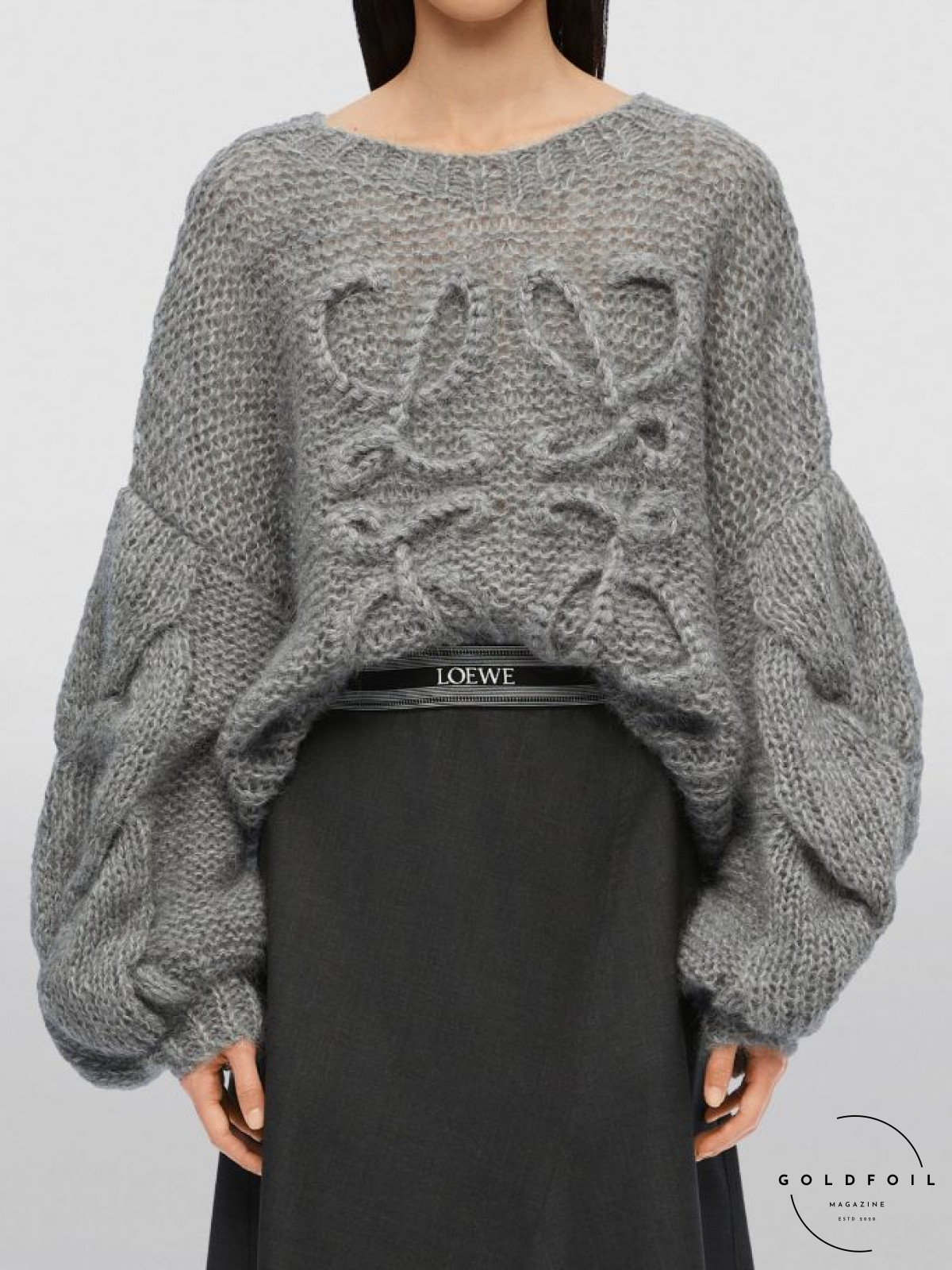 A model wearing a chunky grey knit mohair blend anagram sweater from Loewe