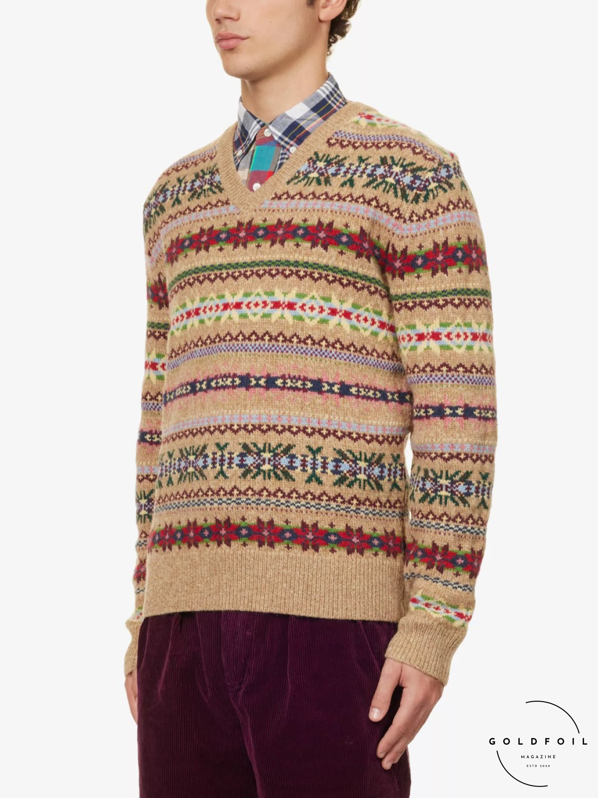 A Polo Ralph Lauren men's knit jumper in Christmas patterns perfect for the festive season, with a V neck complimented by a checkered shirt and burgundy trousers