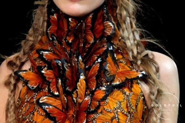 A butterfly dress by Alexander McQueen, a sculpted orange dress with a neck decoration