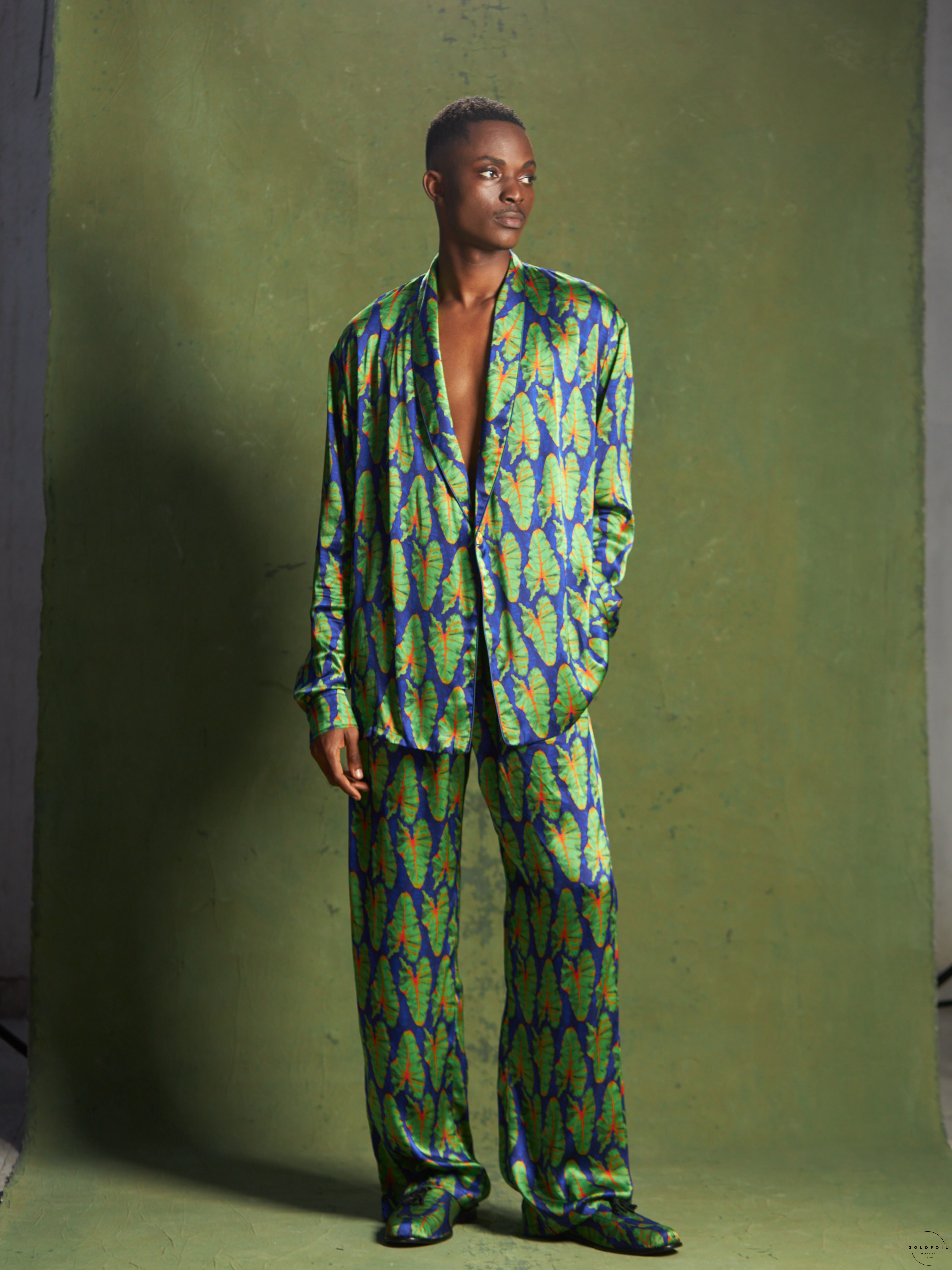 Banke Kuku Menswear  blue set - a relaxed blue blazer covered in green leaves matched with relaxed trousers and loafers in the same pattern