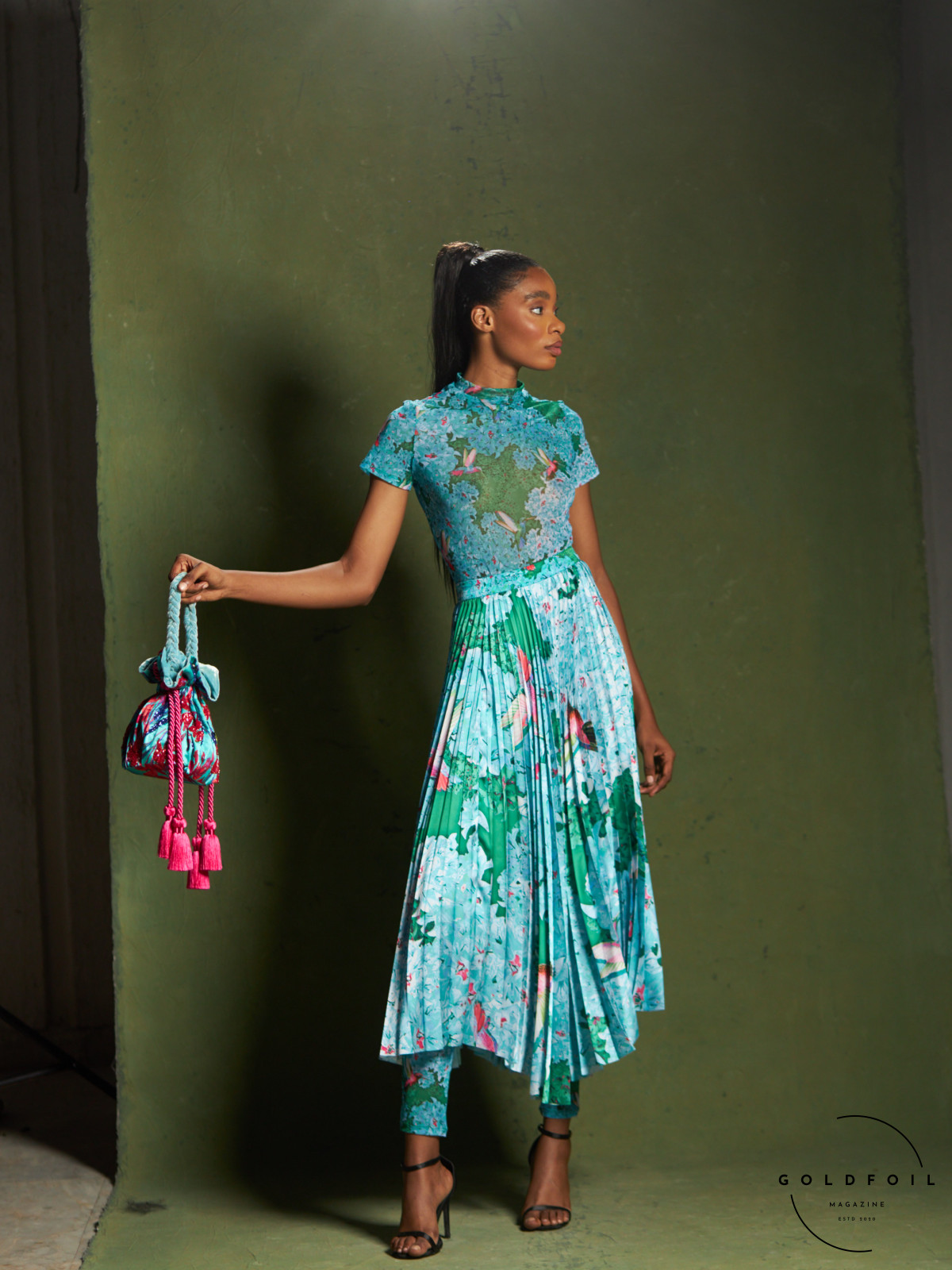 Banke Kuku showcases a colourful collection, in this photo we can see a long dress with a pleated bottom half in a stunning vibrant marine blue