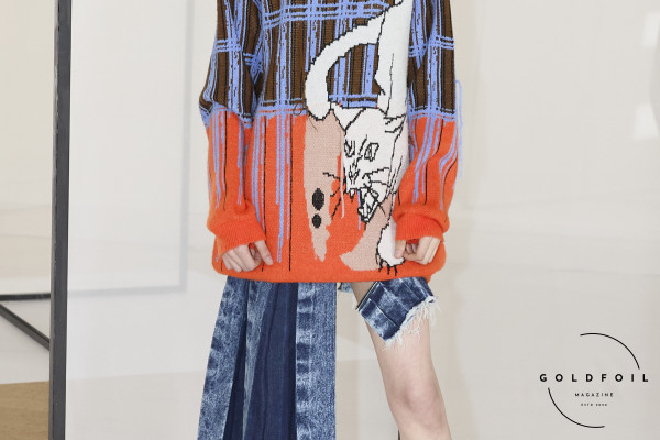 KGL presented their new AW collection as part of London Fashion Week. This outfit is a long jumper dress with a cat illustration and a side pleated denim skirt