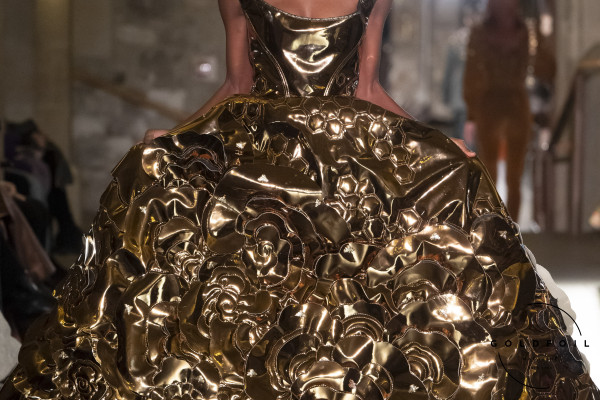 Mithridate AW24 at London Fashion Week showing a model wearing a dress covered in gold metallic roses