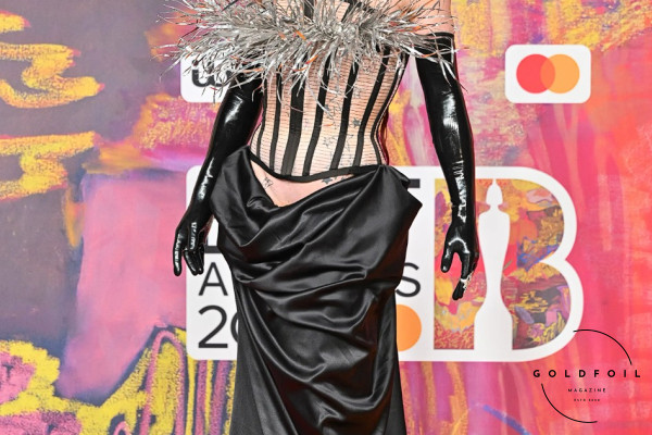Bimini wore a corset with a silver fringe, and a beautifully draped black skirt with hardware and mesh elements