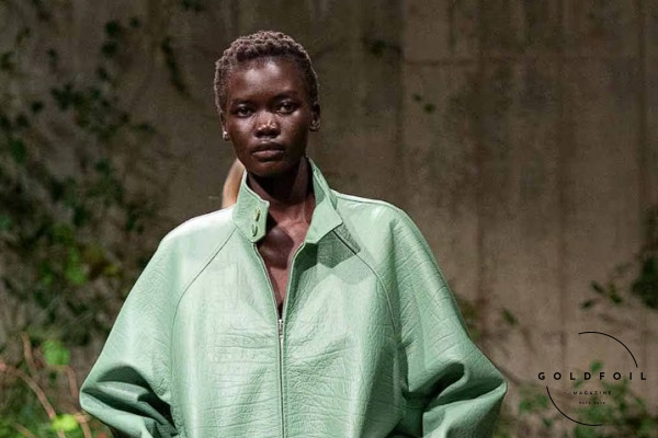 A runway model wears an organza dress, covered by a green leather bomber jacket.Sabato De Sarno presented his Gucci Cruise 2025 collection at the Tate Modern dedicated to London.